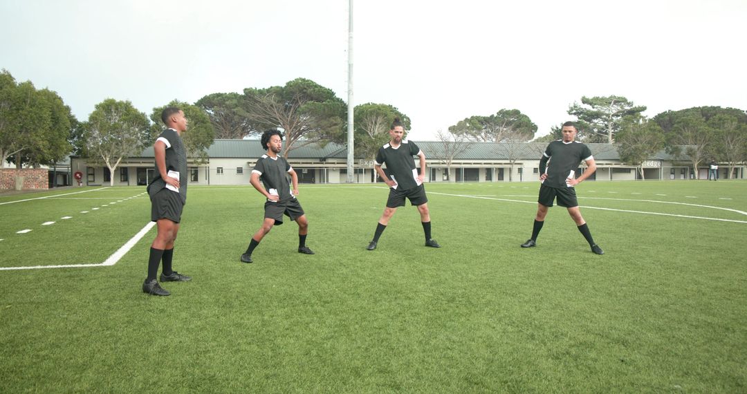 Soccer Players Stretching on Field for Warm-Up