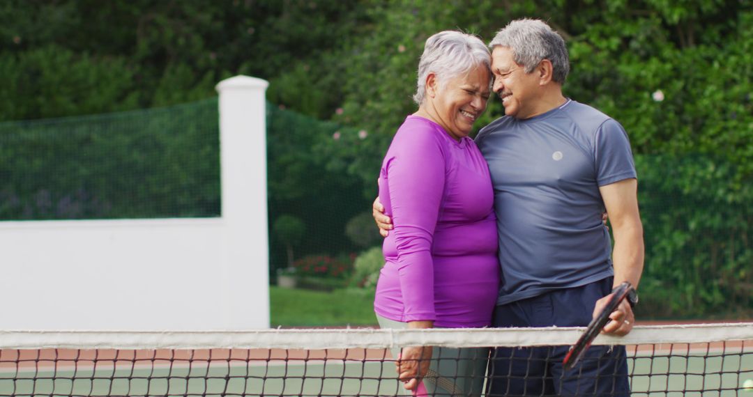 Senior Couple Embracing on Tennis Court Showing Love - Free Images, Stock Photos and Pictures on Pikwizard.com