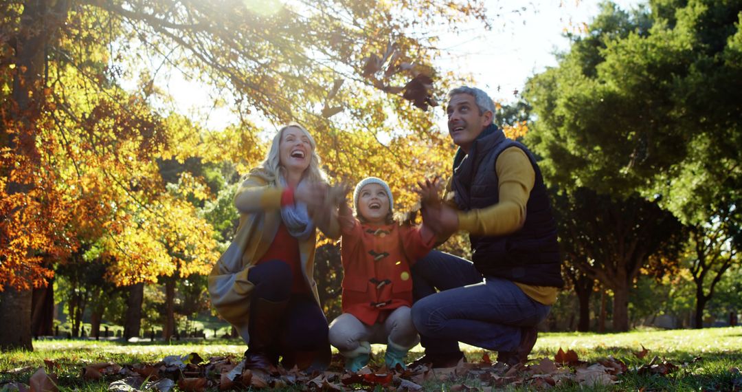 Happy Family Enjoying Autumn Day in Park Under Trees - Free Images, Stock Photos and Pictures on Pikwizard.com