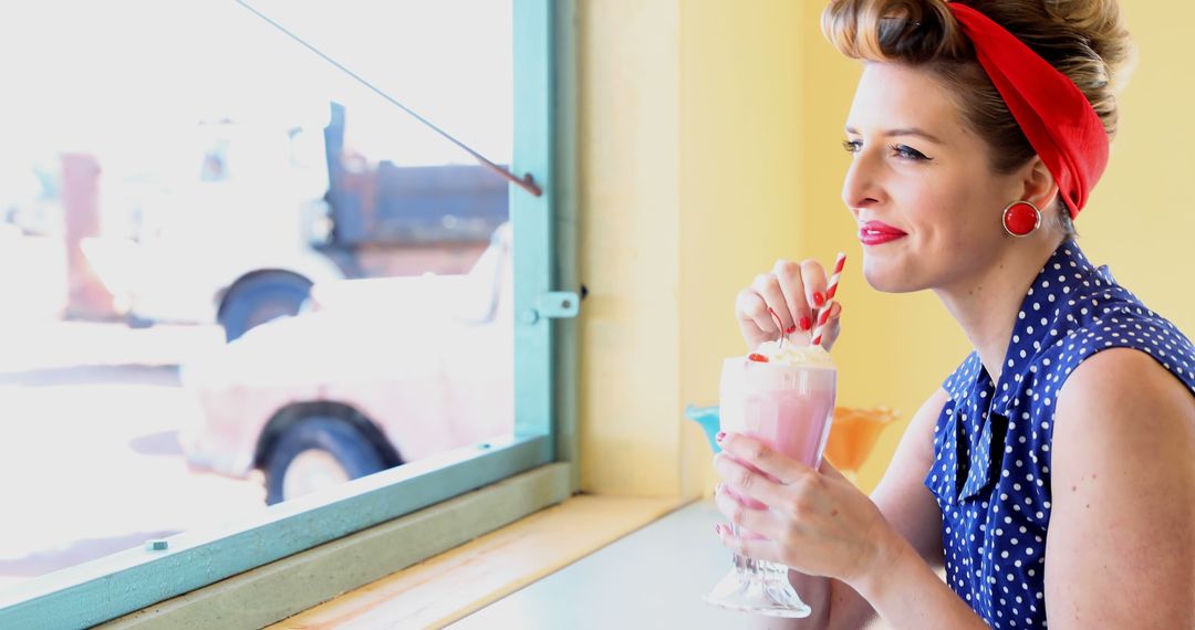 Retro Woman Drinking Milkshake by Window in 1950s Inspired Diner - Free Images, Stock Photos and Pictures on Pikwizard.com