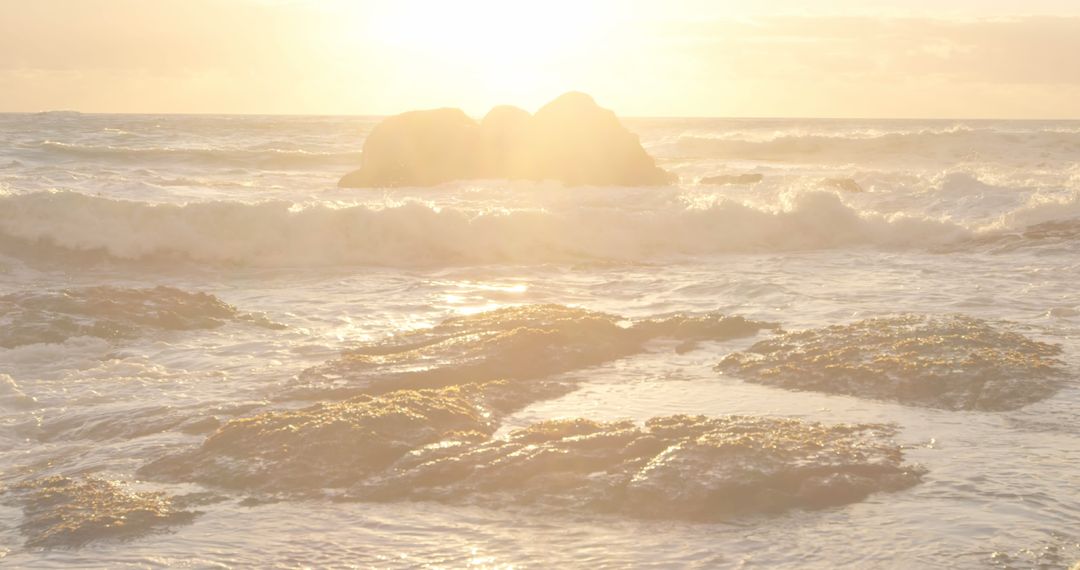 Sunlit Rocky Shoreline with Ocean Waves at Sunset