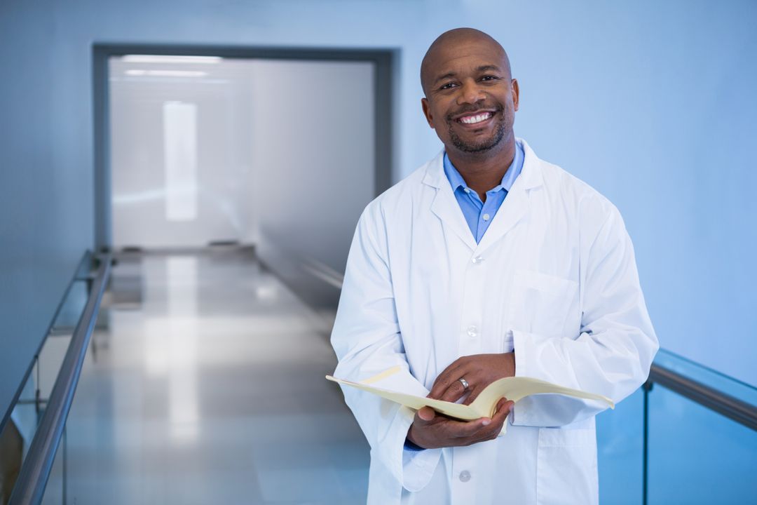 Smiling Doctor Holding Medical Chart in Hospital Corridor