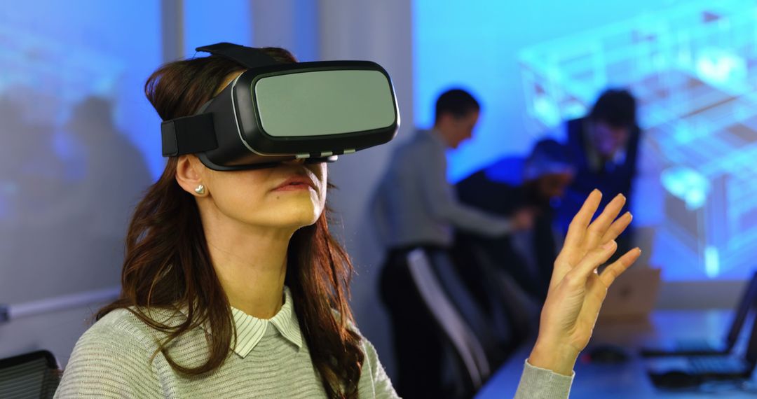 Young Woman Engaging with Virtual Reality in Modern Office - Free Images, Stock Photos and Pictures on Pikwizard.com