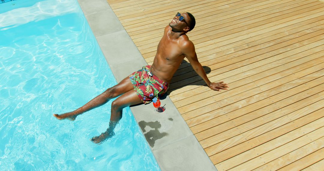 Man Relaxing by Pool in Swimming Trunks on Sunny Day - Free Images, Stock Photos and Pictures on Pikwizard.com