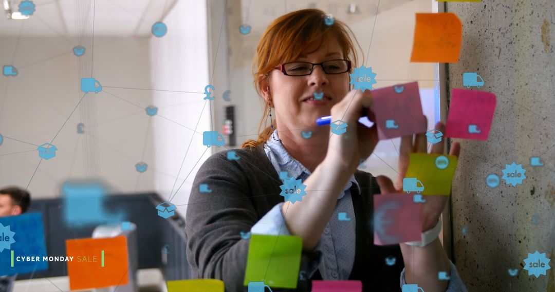 Professional woman brainstorming with colorful sticky notes on glass wall in office - Free Images, Stock Photos and Pictures on Pikwizard.com