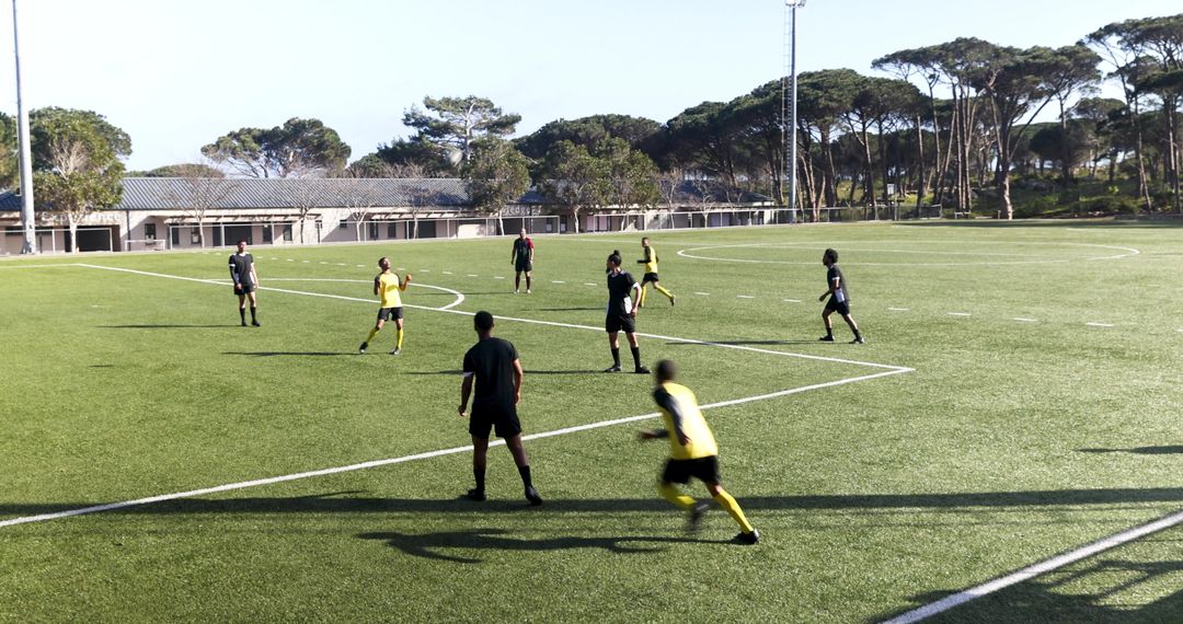Soccer Teams Practicing Under Clear Sky on Verdant Field