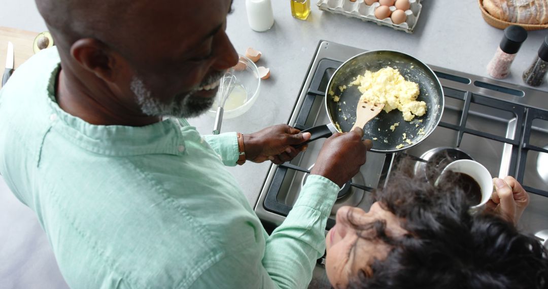 Man Cooking Scrambled Eggs with Partner in Modern Kitchen - Free Images, Stock Photos and Pictures on Pikwizard.com