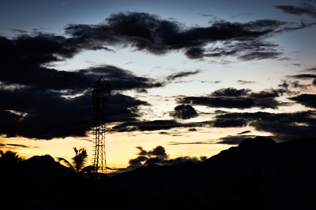 Sunset Silhouette over Mountains and Cell Tower - Free Images, Stock Photos and Pictures on Pikwizard.com