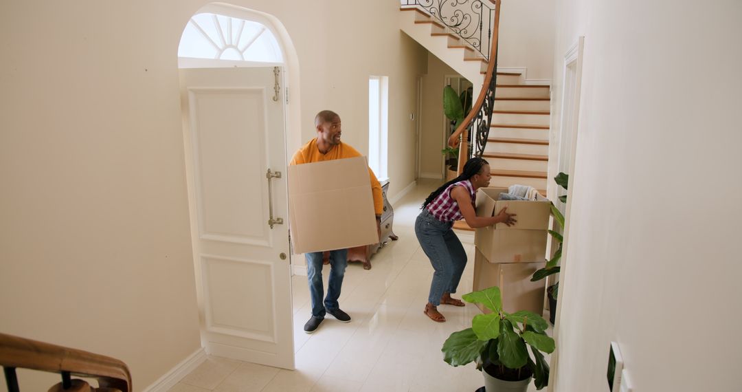 Couple Moving into New Home with Boxes and Climbing Stairs
