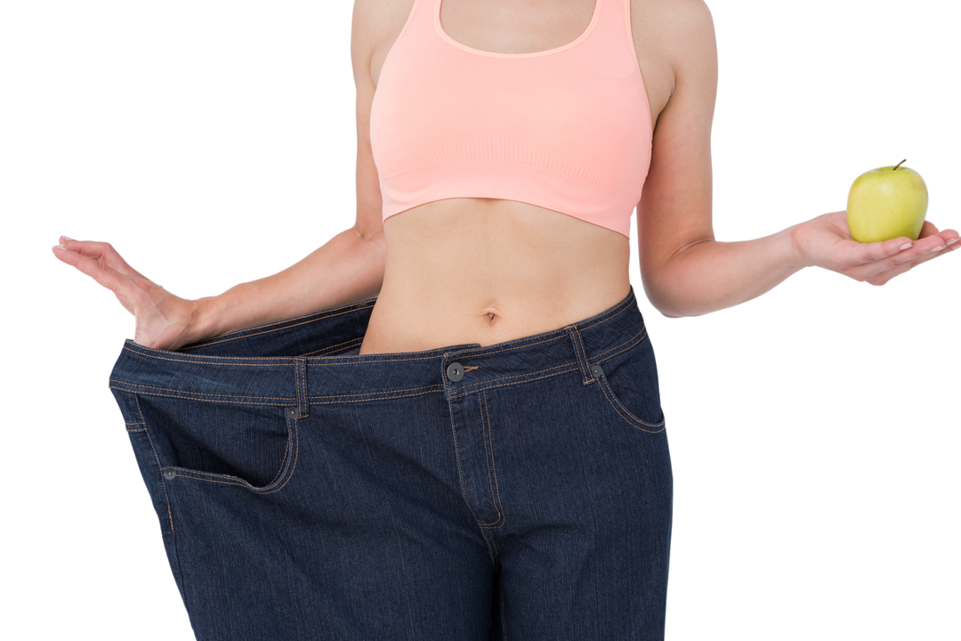 Transparent fitness woman in loose jeans holding apple symbolizing weight loss - Download Free Stock Images Pikwizard.com