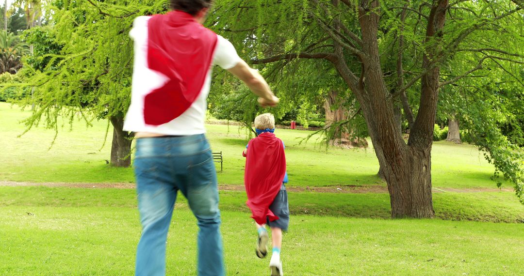 Father and Son Playing Superheroes Wearing Red Capes in Park - Free Images, Stock Photos and Pictures on Pikwizard.com