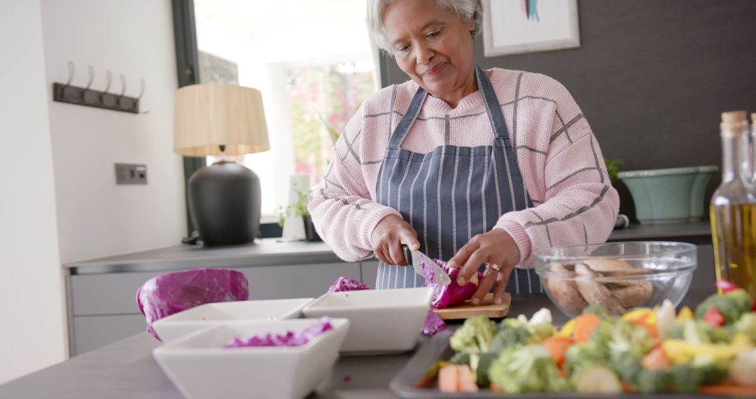 Senior Woman Chopping Vegetables in Modern Kitchen Preparing Healthy Meal - Free Images, Stock Photos and Pictures on Pikwizard.com