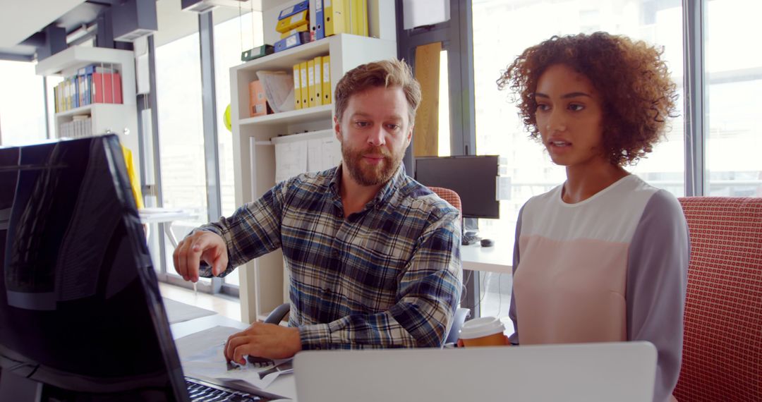 Teamwork in Modern Office with Caucasian Man and Biracial Woman Collaborating