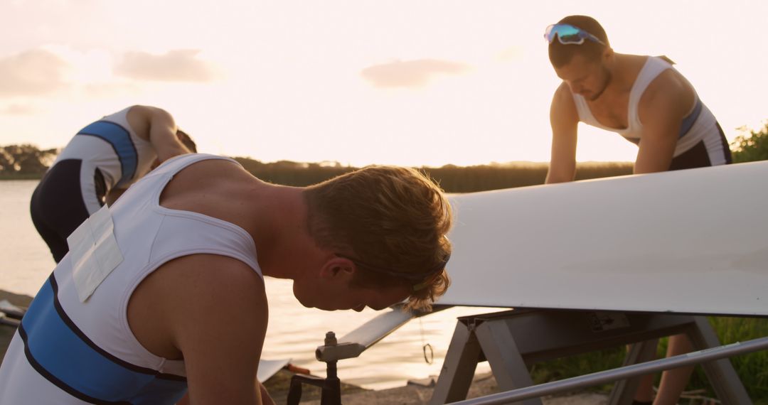 Male Rowing Team Preparing Boat at Sunset - Free Images, Stock Photos and Pictures on Pikwizard.com