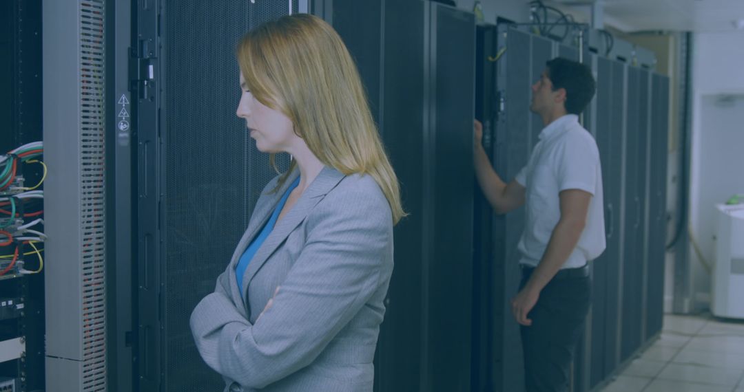 IT Professionals Maintain Secure Server Racks in Data Center