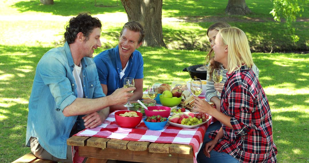 Friends Enjoying Outdoor Picnic in Park on Sunny Day - Free Images, Stock Photos and Pictures on Pikwizard.com