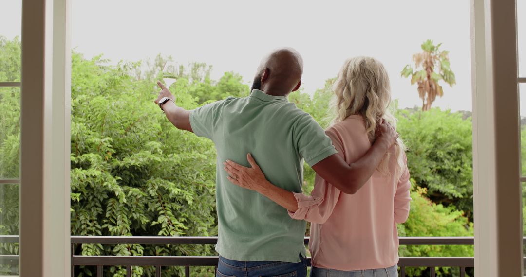 Couple Embracing on Balcony Overlooking Nature