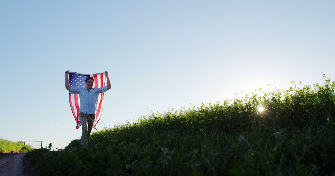 Young Man Carrying American Flag Over Green Field - Free Images, Stock Photos and Pictures on Pikwizard.com