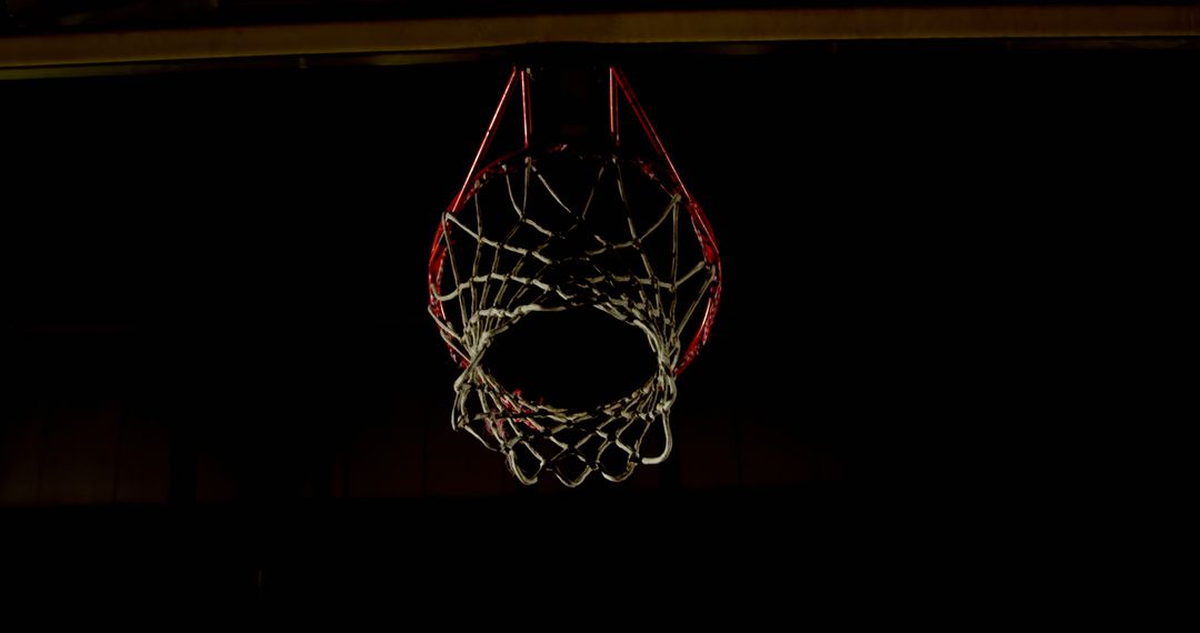 Dimly Lit Basketball Hoop Against Dark Background - Free Images, Stock Photos and Pictures on Pikwizard.com