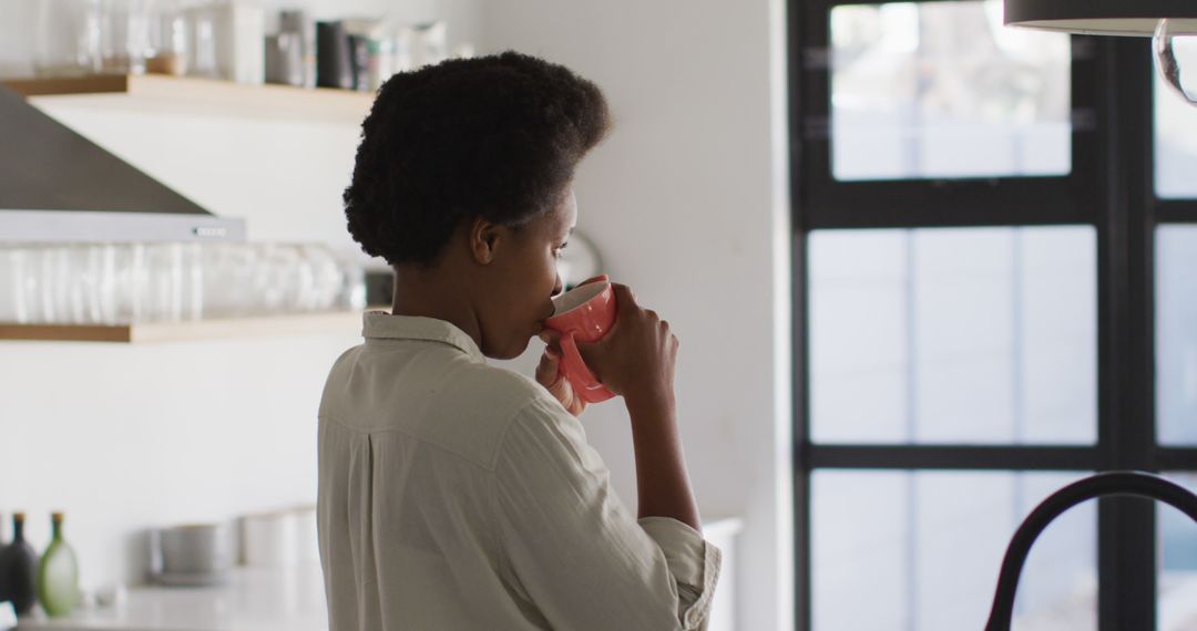 Morning Routine Woman Drinking Coffee in Modern Kitchen - Free Images, Stock Photos and Pictures on Pikwizard.com