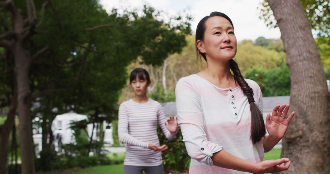 Women Practicing Tai Chi Outdoors in Tranquil Park - Free Images, Stock Photos and Pictures on Pikwizard.com