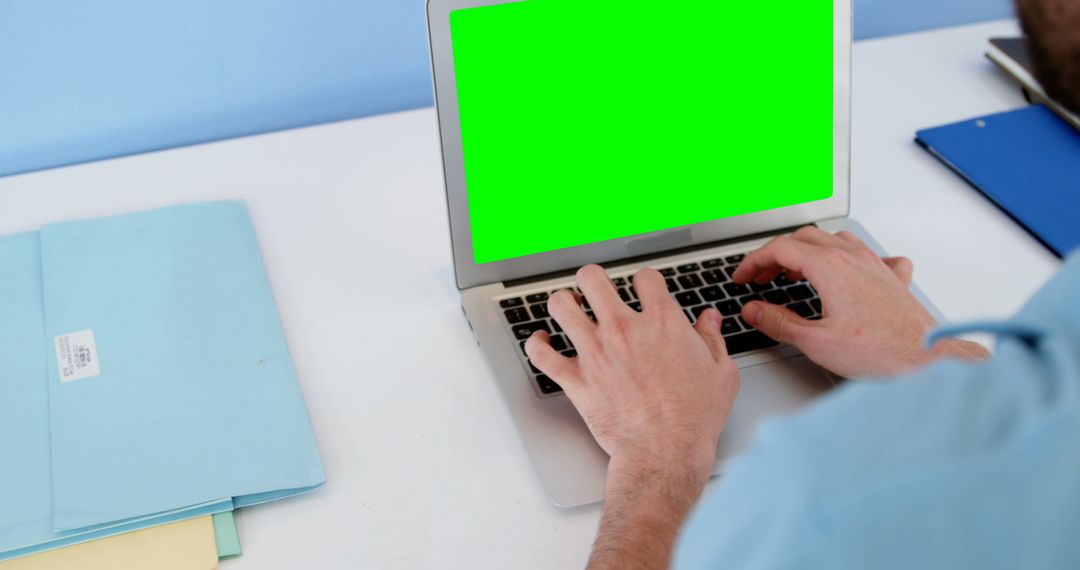 Man Typing on Laptop with Green Screen Monitor, Office Desk Workspace - Free Images, Stock Photos and Pictures on Pikwizard.com