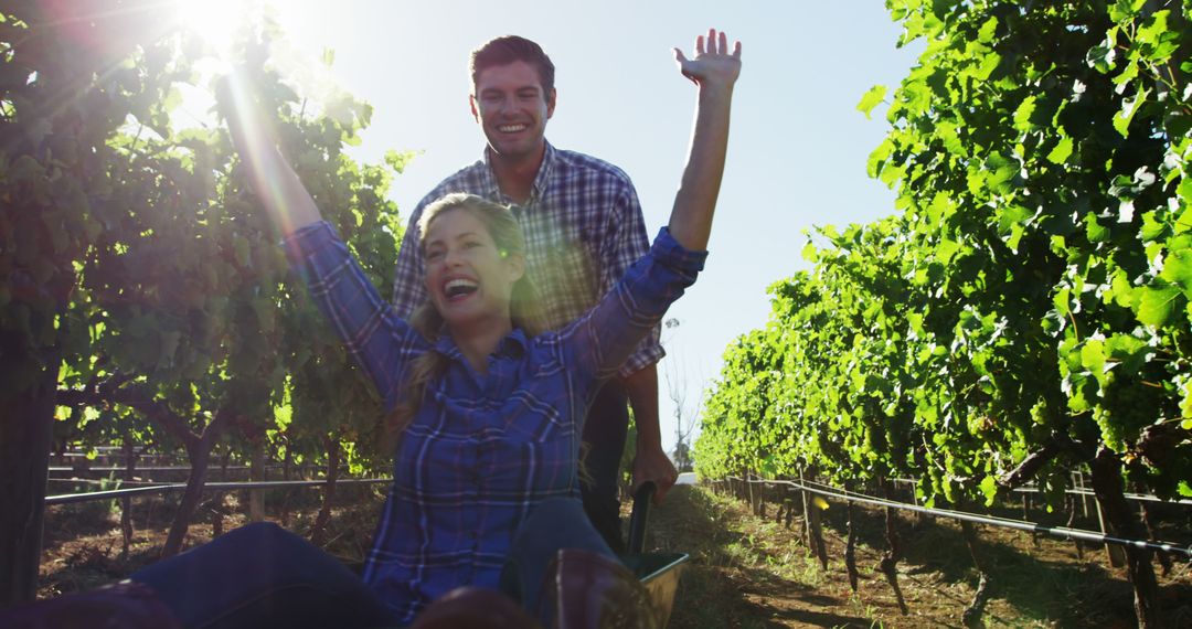 Couple Enjoying Playful Adventure in Vineyard During Sunny Day - Free Images, Stock Photos and Pictures on Pikwizard.com