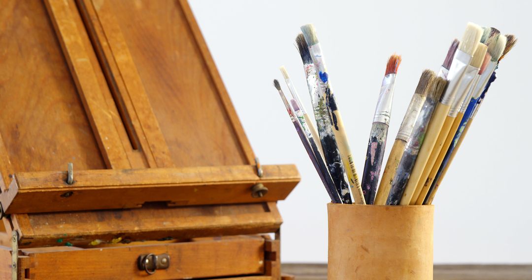 Used Artists' Paintbrushes in Holder Near Wooden Easel - Free Images, Stock Photos and Pictures on Pikwizard.com