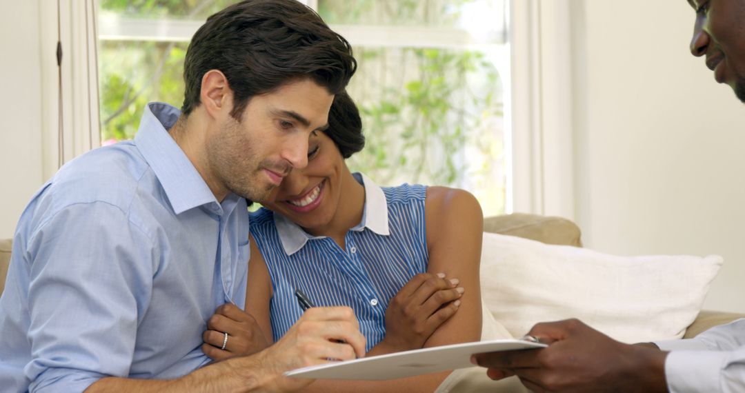 Happy Couple Signing Real Estate Contract at Home