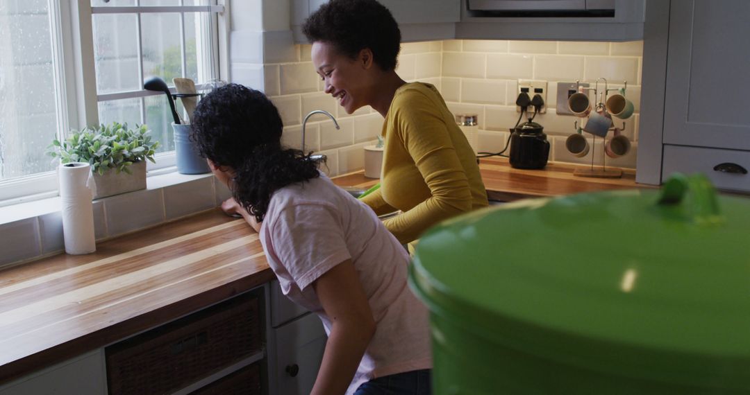 Two Women Enjoying Time Together in Bright Kitchen - Free Images, Stock Photos and Pictures on Pikwizard.com