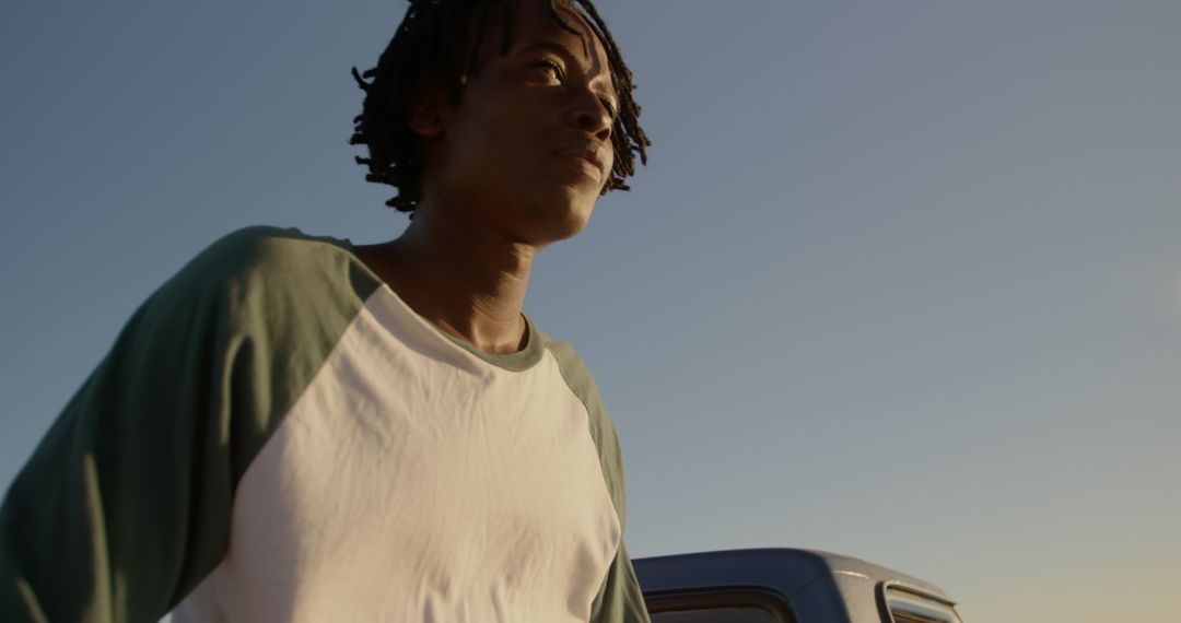 Contemplative Young Man Relaxing by the Oceanside