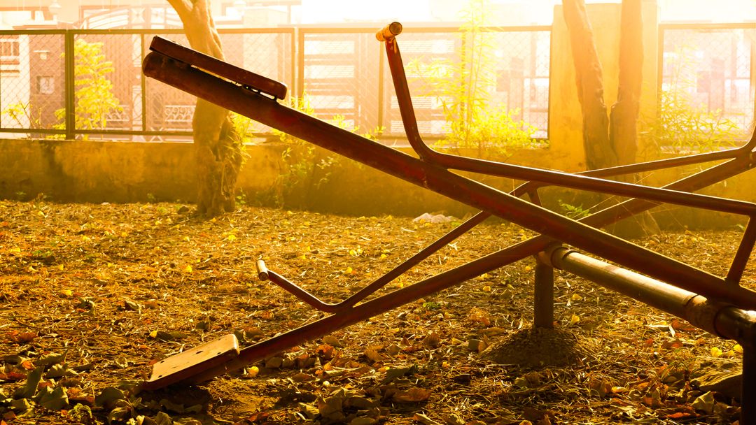 Sunlit Abandoned Seesaw in Park - Free Images, Stock Photos and Pictures on Pikwizard.com