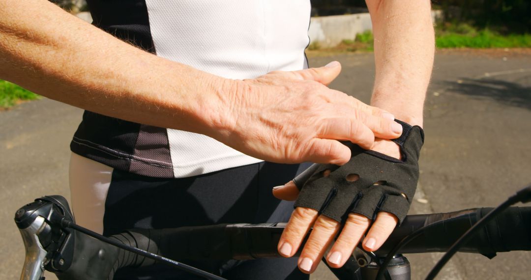 Close-up of Cyclist Adjusting Protective Gloves - Free Images, Stock Photos and Pictures on Pikwizard.com