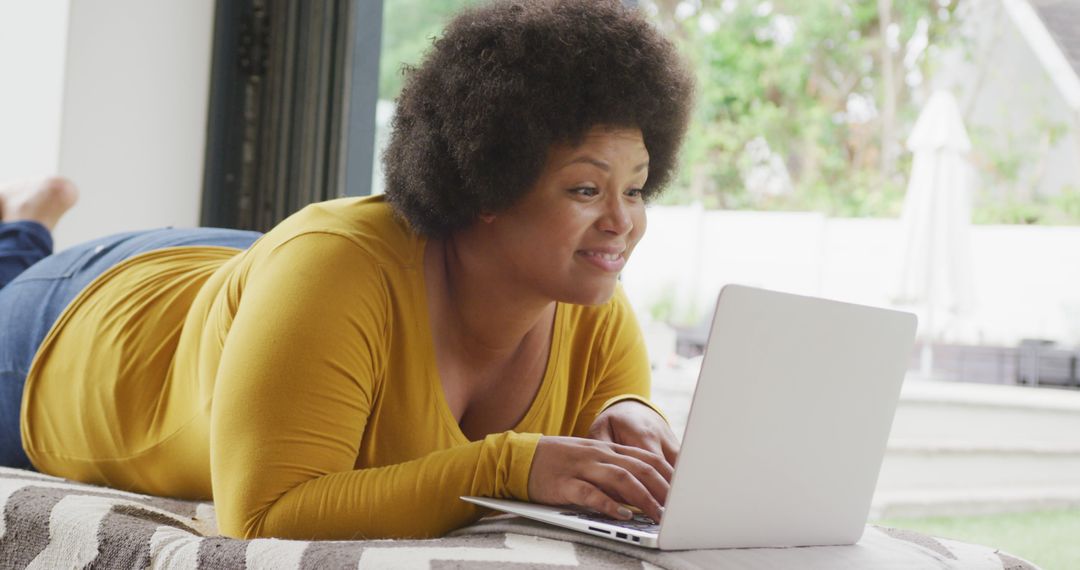 Smiling Woman Relaxing with Laptop Indoors - Free Images, Stock Photos and Pictures on Pikwizard.com