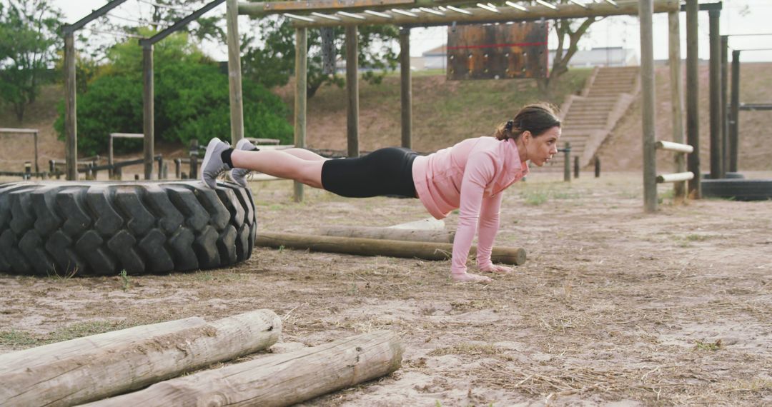 Woman Exercising with Push-ups in Outdoor Obstacle Course - Free Images, Stock Photos and Pictures on Pikwizard.com