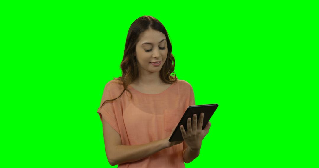 Young Woman Using Digital Tablet with Green Background - Free Images, Stock Photos and Pictures on Pikwizard.com