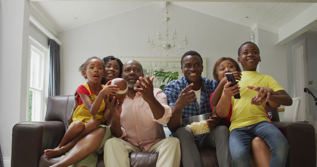 Excited African American Family Watching TV Together on Cozy Sofa - Free Images, Stock Photos and Pictures on Pikwizard.com