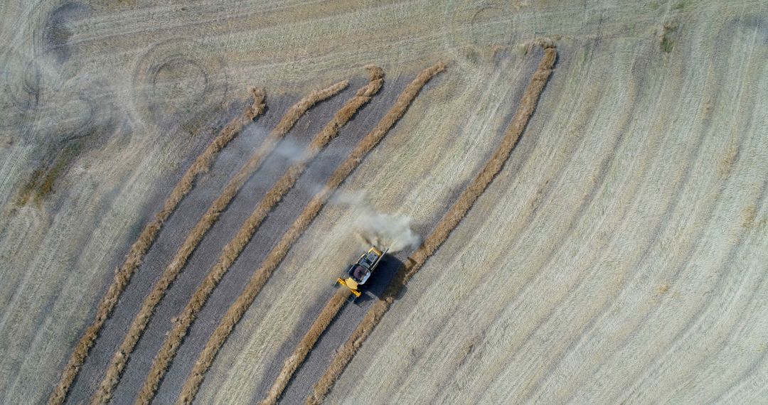 Aerial View of Harvesting Machine in Field with Curved Crop Rows - Free Images, Stock Photos and Pictures on Pikwizard.com