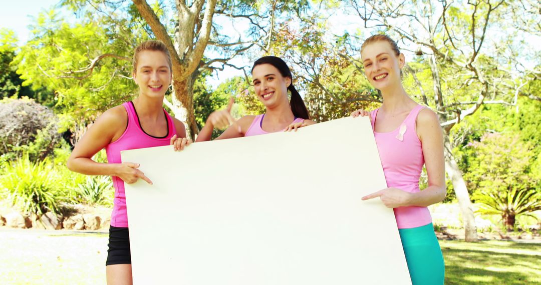 Three Women in Pink Holding Blank Sign Board Outdoors for Awareness Campaign - Free Images, Stock Photos and Pictures on Pikwizard.com