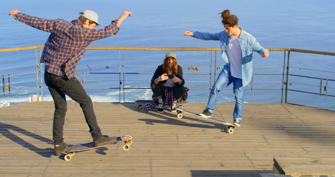 Young Skateboarders Display Tricks on Oceanfront Pier - Free Images, Stock Photos and Pictures on Pikwizard.com