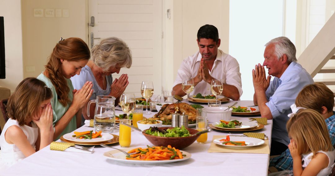 Family Praying Before Thanksgiving Dinner - Free Images, Stock Photos and Pictures on Pikwizard.com