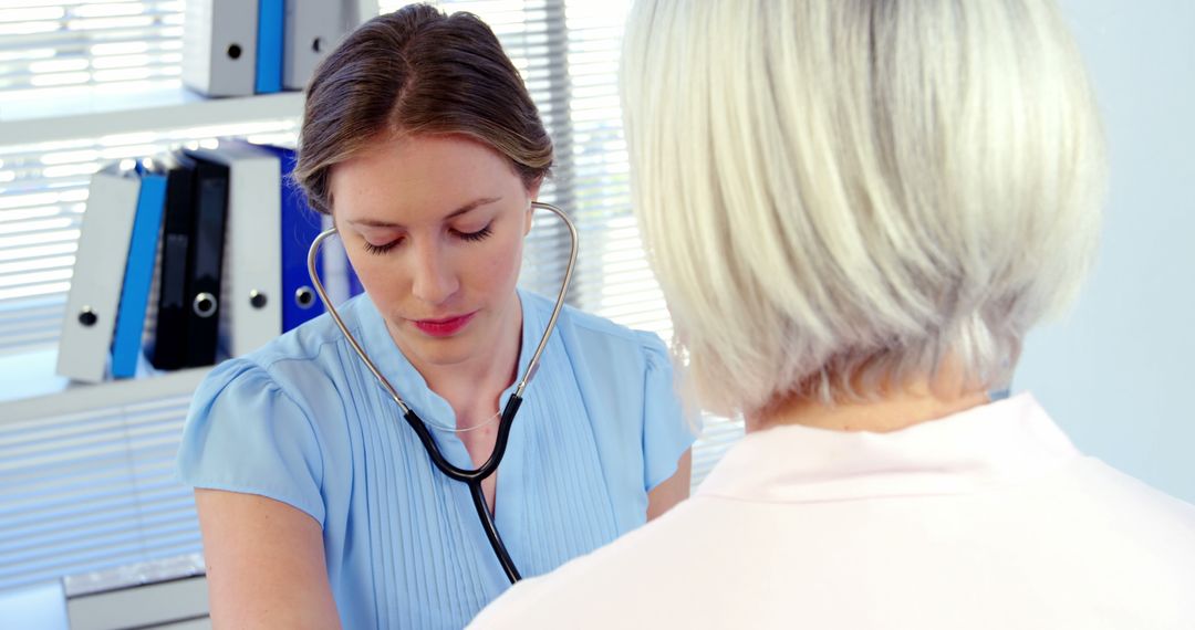 Female Doctor Checking Patient with Stethoscope at Clinic - Free Images, Stock Photos and Pictures on Pikwizard.com