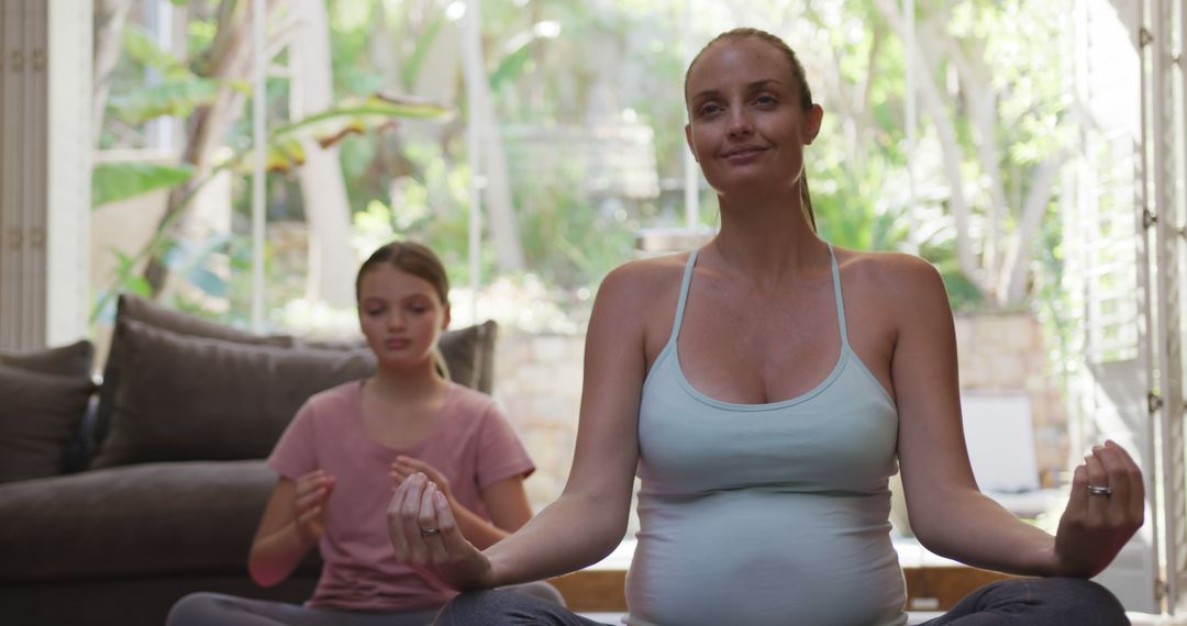 Pregnant Woman Practicing Meditation with Young Girl at Home - Free Images, Stock Photos and Pictures on Pikwizard.com