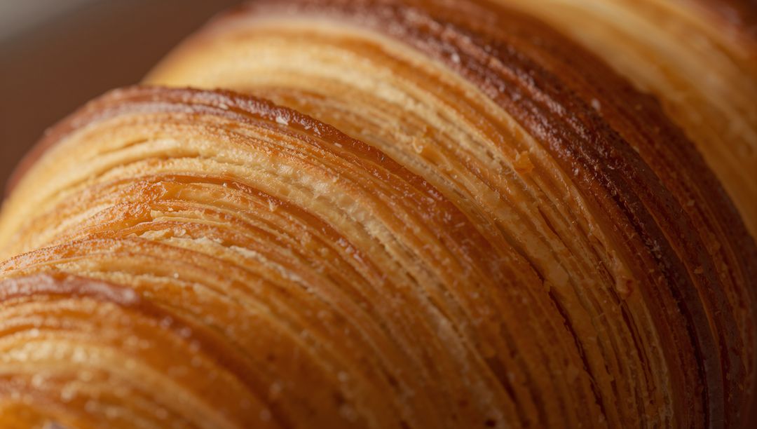Buttery Laminated Spiral Pastry Showing Golden Flaky Layers and Caramelized Sugar Gloss