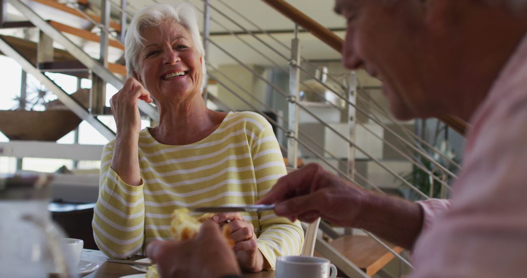 Joyful Senior Couple Enjoying Breakfast at Home