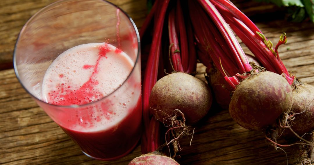 Fresh Beetroot Juice in Glass with Whole Beetroots on Wooden Table - Free Images, Stock Photos and Pictures on Pikwizard.com