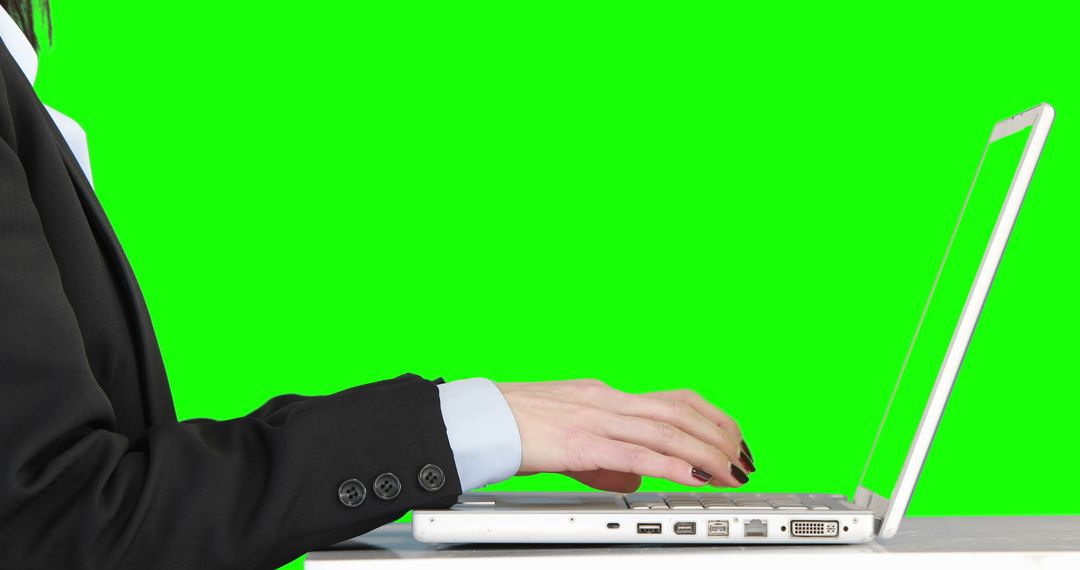 Businesswoman Working on Laptop with Green Screen Background - Free Images, Stock Photos and Pictures on Pikwizard.com