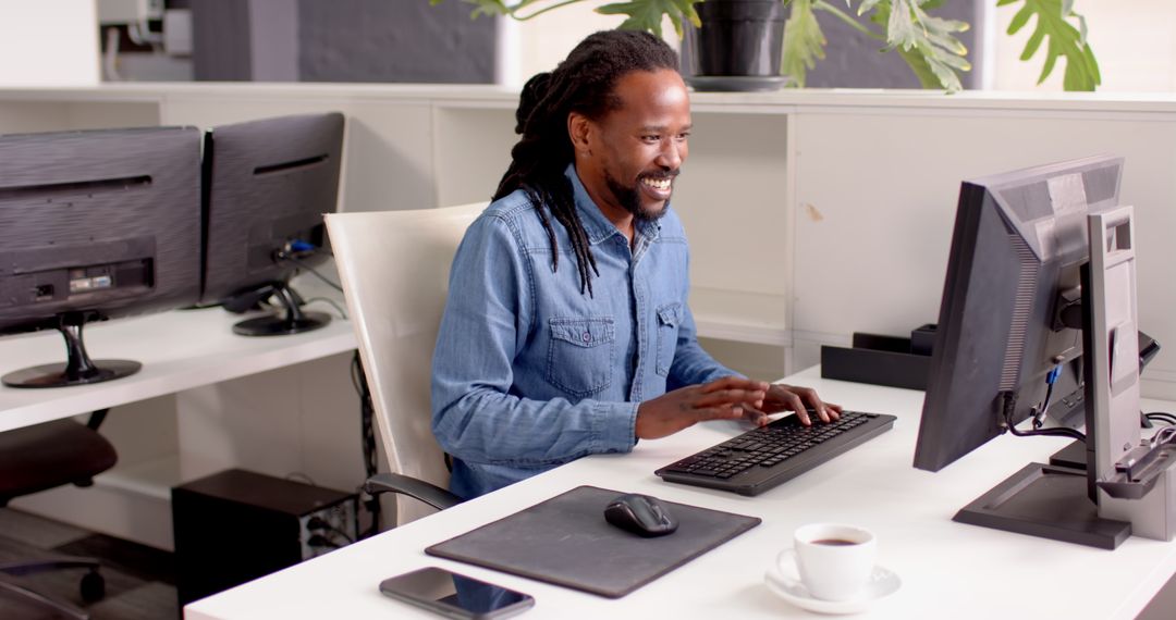 Man engaged in computer work at modern office desk