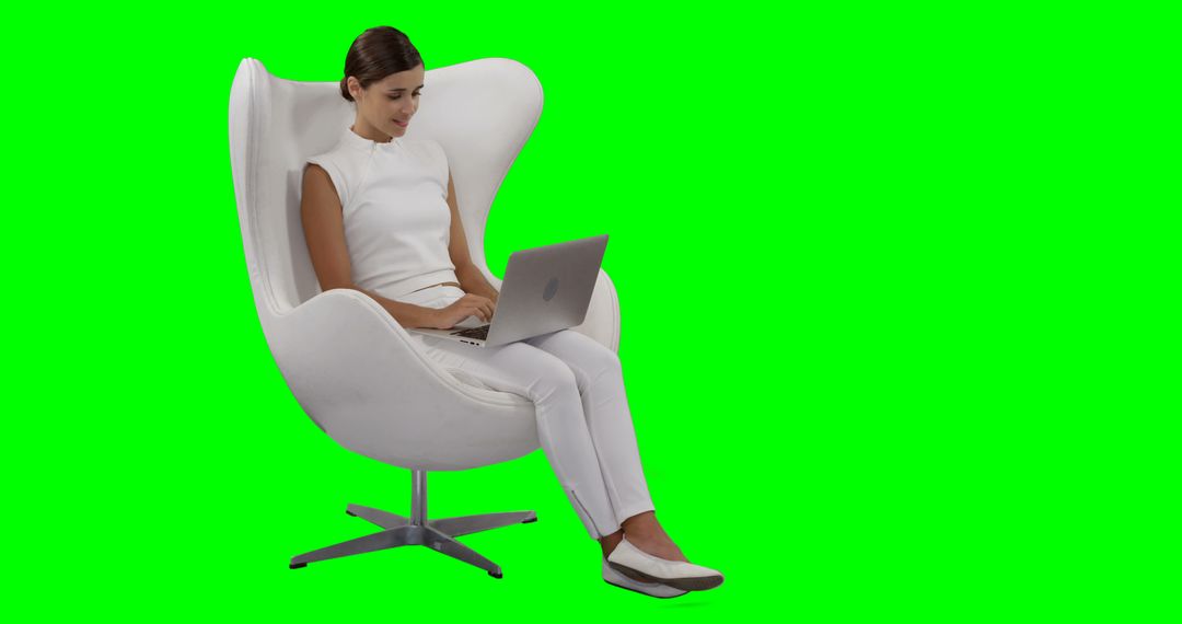 Young Woman Working on Laptop in Modern White Chair with Green Screen Background - Free Images, Stock Photos and Pictures on Pikwizard.com