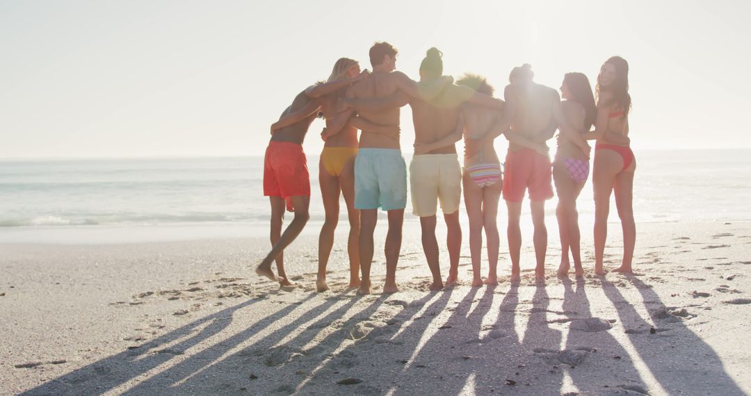 Group of Friends Embracing on a Sunny Beach - Free Images, Stock Photos and Pictures on Pikwizard.com